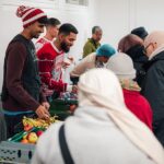Douglas Luiz (centre) helps out at the Salaam Shalom Kitchen in Nottingham that provides free hot meals to those in need every Wednesday. ‘It’s a special day,' he says, 'because sometimes you need to see real life'