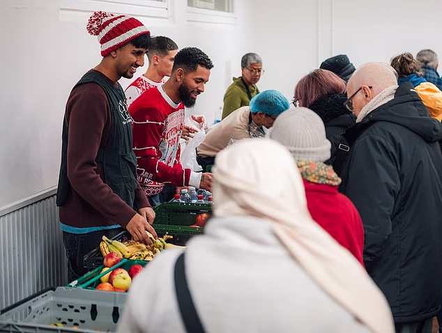 Douglas Luiz (centre) helps out at the Salaam Shalom Kitchen in Nottingham that provides free hot meals to those in need every Wednesday. ‘It’s a special day,' he says, 'because sometimes you need to see real life'