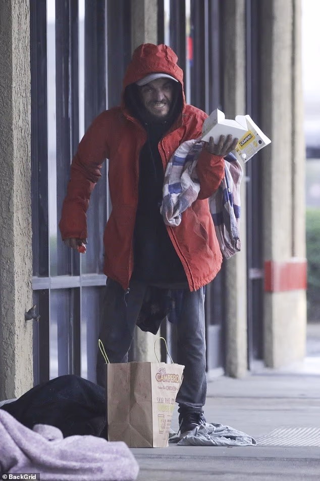 Former Nickelodeon child star Tylor Chase is now receiving medical care after shocking fans with viral videos of him living on the street, the Daily Mail has learned; pictured Wednesday on a rainy Christmas Eve in Southern California